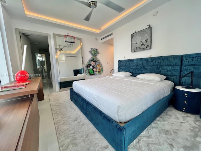 bedroom featuring ceiling fan and a raised ceiling