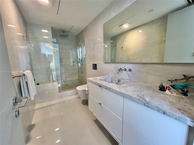 bathroom featuring vanity, toilet, decorative backsplash, and tile walls