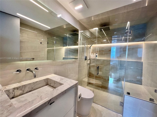 bathroom with vanity, toilet, and a shower with shower door