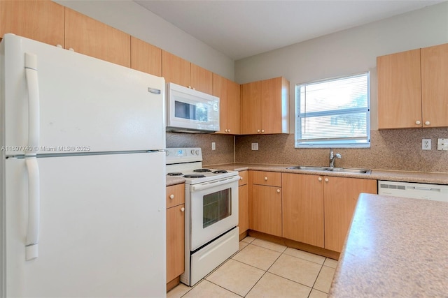 kitchen featuring a sink, white appliances, light countertops, light tile patterned floors, and decorative backsplash