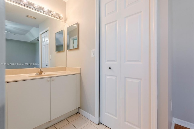 bathroom with vanity, tile patterned floors, and baseboards