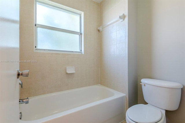 bathroom with a tub and toilet