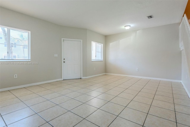 unfurnished room featuring baseboards