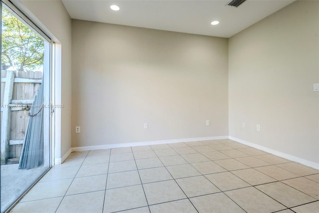 spare room featuring recessed lighting, visible vents, and baseboards