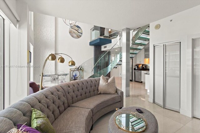 60 SW 13th St Unit 4606, Miami, FL 33130 - living area with stairs, a chandelier, and light tile patterned floors