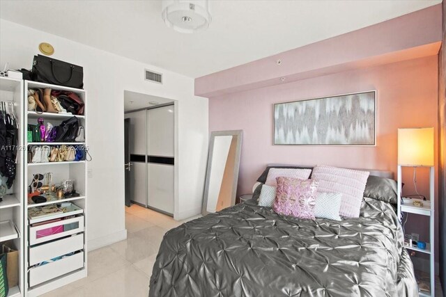 tiled bedroom featuring a closet