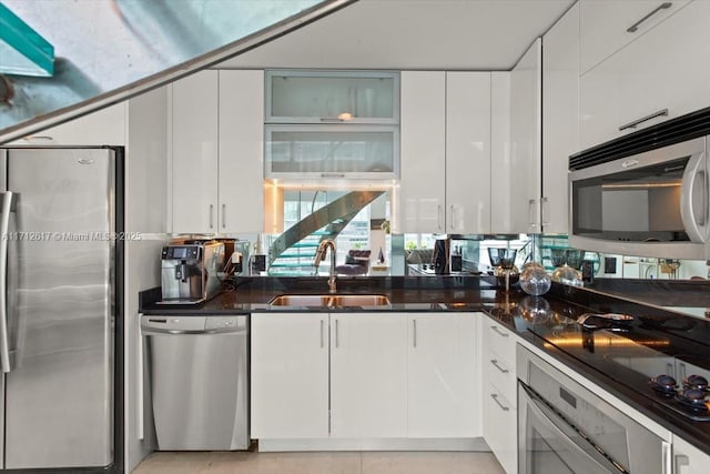 60 SW 13th St Unit 4606, Miami, FL 33130 - kitchen with stainless steel appliances, white cabinetry, glass insert cabinets, and light tile patterned floors