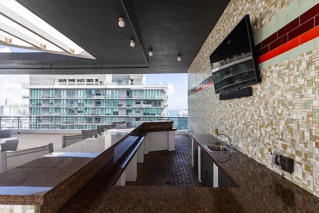 interior space with a skylight, sink, and dark tile patterned floors