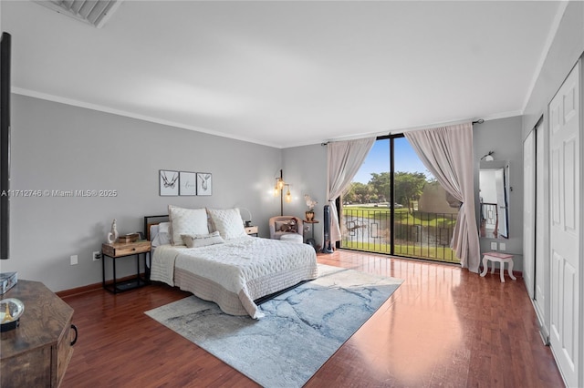 bedroom with ornamental molding, access to outside, and dark hardwood / wood-style floors