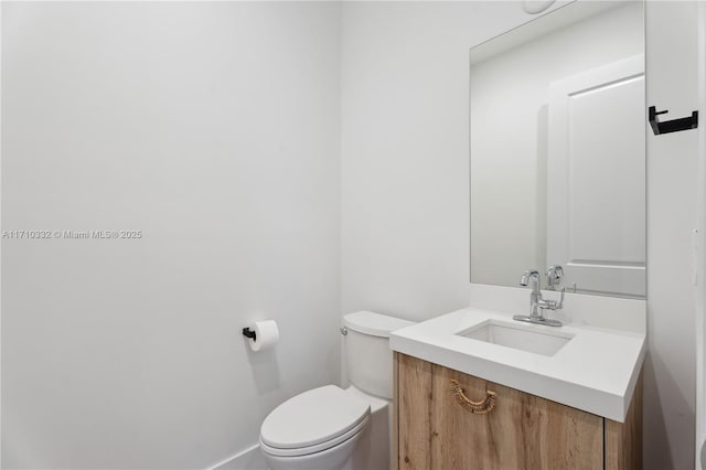 bathroom with toilet and vanity