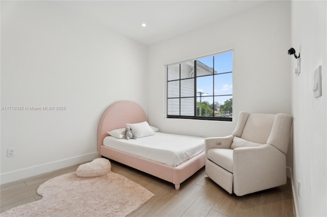 bedroom with light wood-style floors, recessed lighting, and baseboards