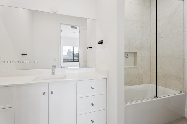 bathroom featuring vanity and bath / shower combo with glass door