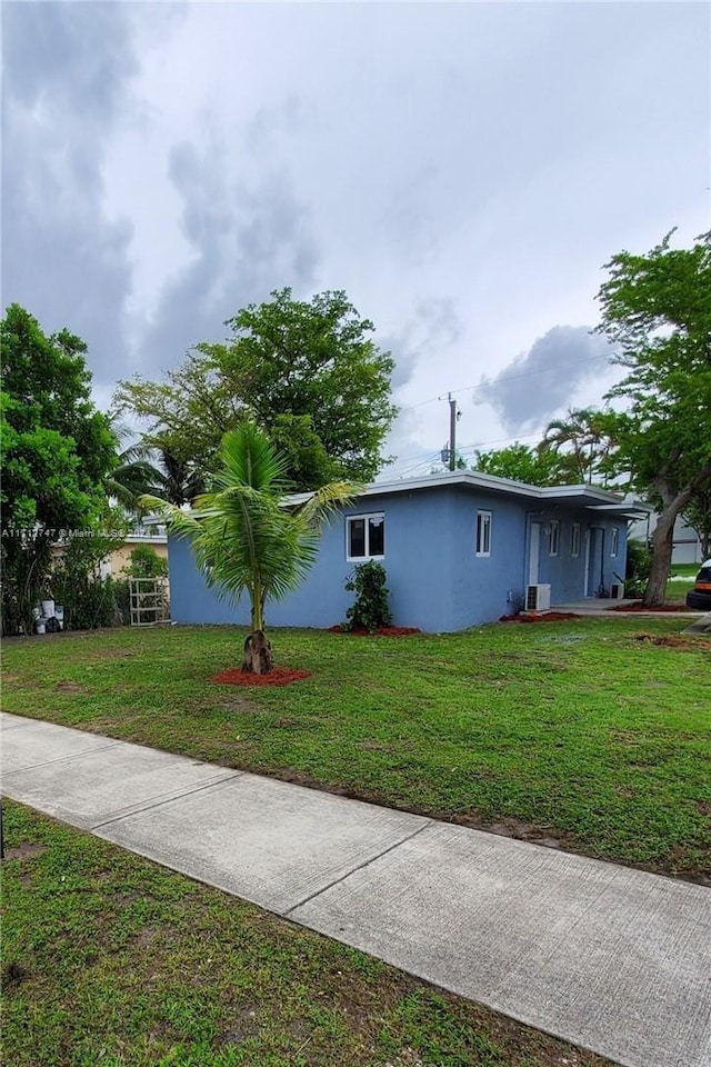 view of side of home featuring a yard