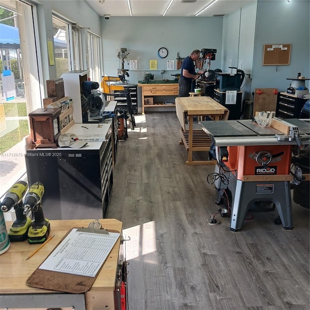 miscellaneous room featuring a workshop area and wood finished floors