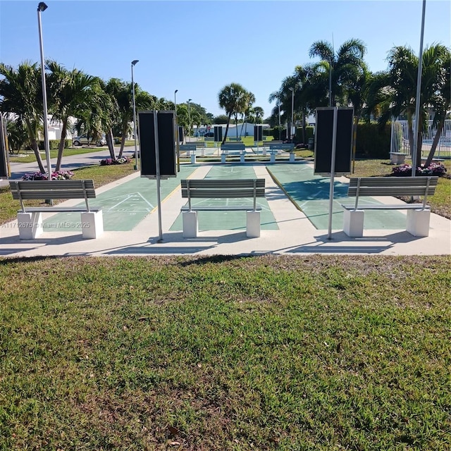view of home's community featuring a lawn and shuffleboard