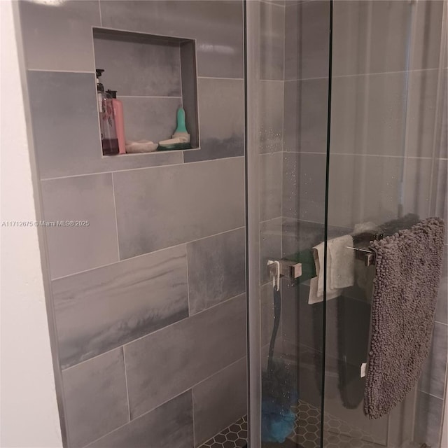 bathroom with a shower with shower door