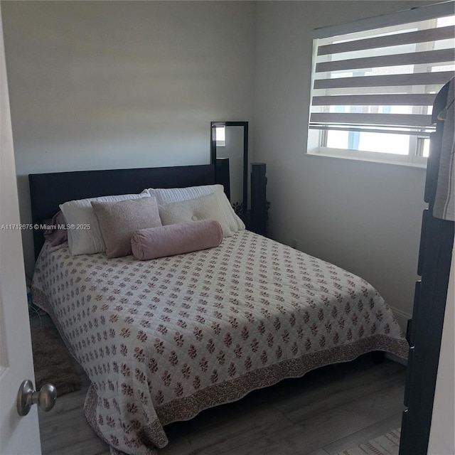 bedroom with hardwood / wood-style floors