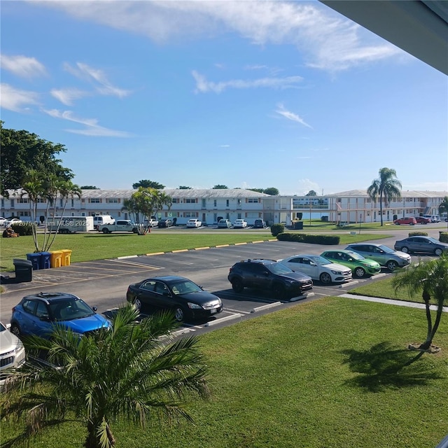 uncovered parking lot featuring a residential view