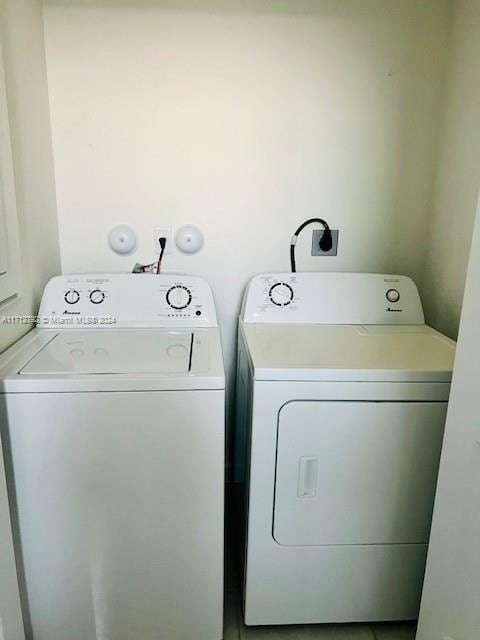 clothes washing area with separate washer and dryer