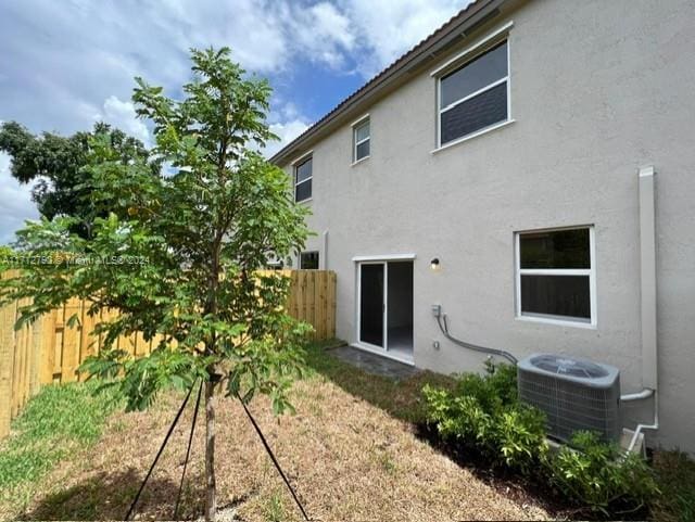 rear view of house with cooling unit