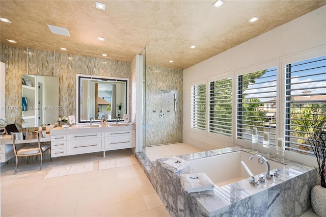 bathroom with independent shower and bath, tile walls, tile patterned floors, and vanity