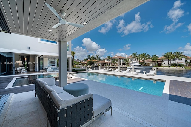 view of swimming pool with ceiling fan, outdoor lounge area, and a patio