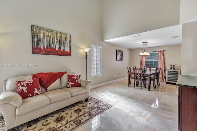 living room with a high ceiling and wine cooler