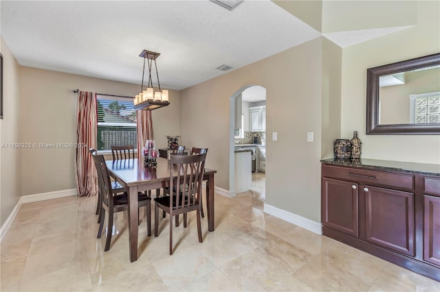 dining space featuring a textured ceiling