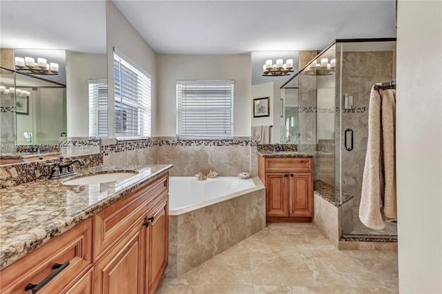 bathroom featuring vanity and separate shower and tub