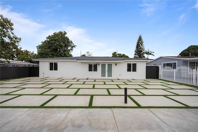 back of house with french doors and a patio