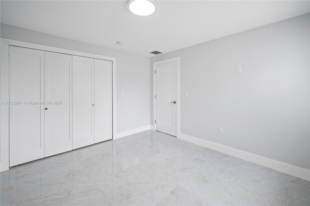 unfurnished bedroom with a closet