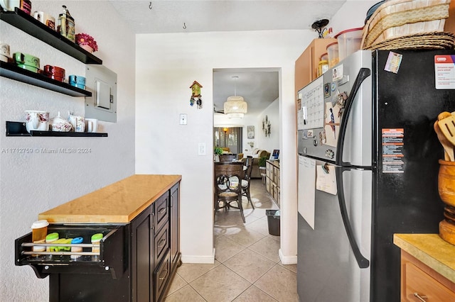 kitchen featuring stainless steel refrigerator and light tile patterned flooring