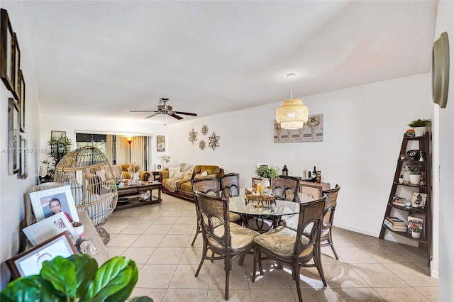 tiled dining area with ceiling fan