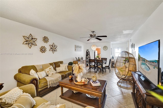 tiled living room with a textured ceiling and ceiling fan