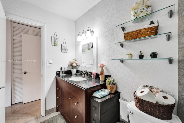 bathroom featuring toilet, vanity, and tile patterned floors