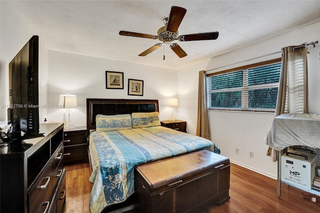 bedroom with wood-type flooring, a textured ceiling, and ceiling fan