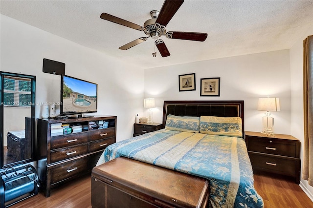 bedroom with a textured ceiling, hardwood / wood-style flooring, and ceiling fan