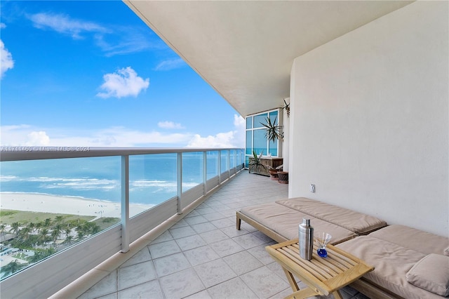 balcony featuring a water view and a beach view