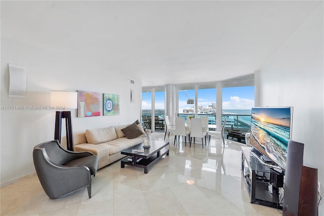 living room featuring expansive windows and light tile patterned floors