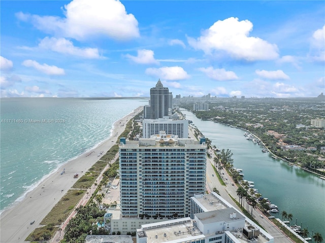 bird's eye view featuring a water view and a beach view