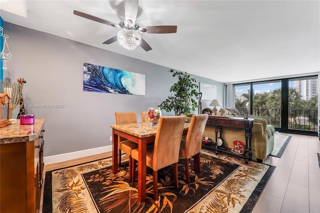 dining area with ceiling fan and floor to ceiling windows