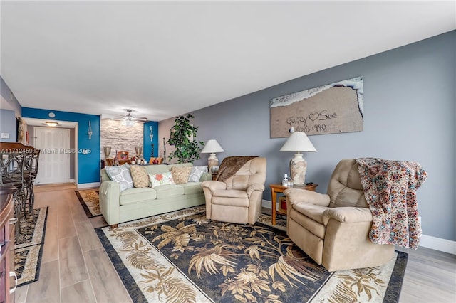 living room with ceiling fan and hardwood / wood-style floors