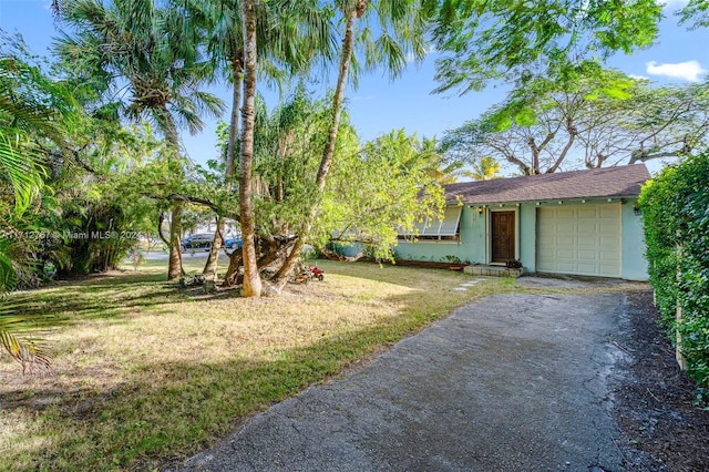 view of front facade with a front yard and a garage