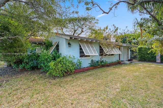 view of home's exterior with a lawn