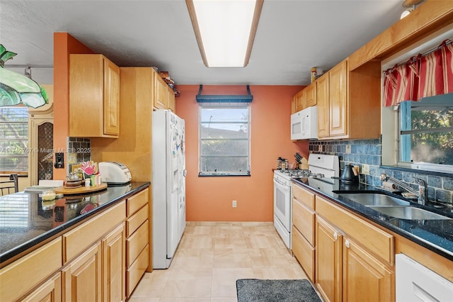 kitchen featuring tasteful backsplash, sink, and white appliances