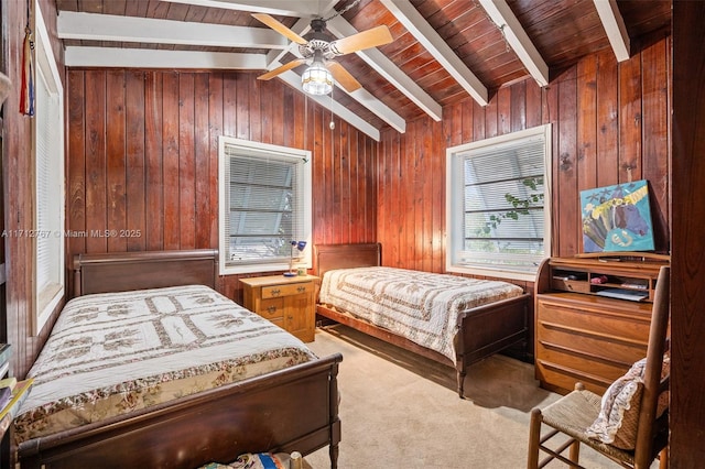 bedroom with light carpet, wooden walls, lofted ceiling with beams, and ceiling fan