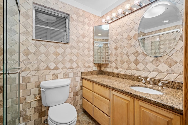 bathroom featuring a shower with door, vanity, and toilet