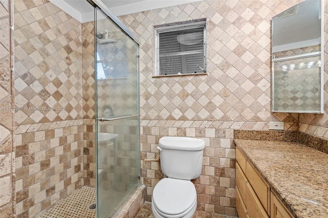 bathroom with vanity, a shower with shower door, and toilet