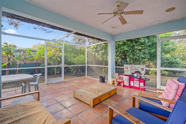 sunroom with a healthy amount of sunlight and ceiling fan