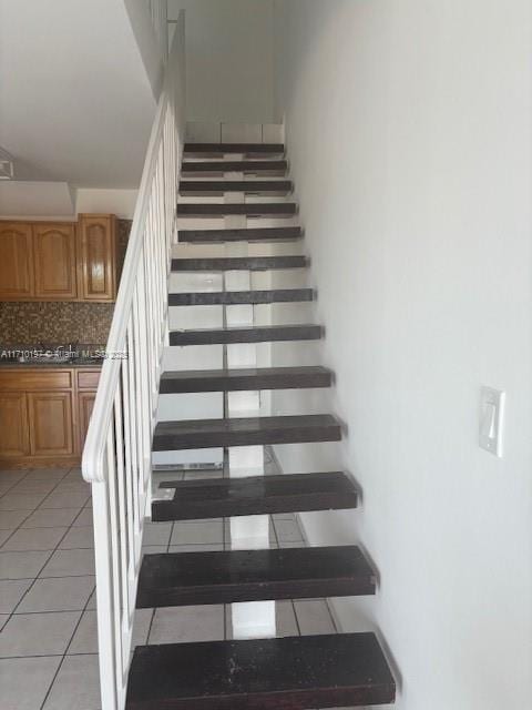 stairway featuring tile patterned floors